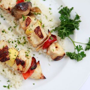 Chicken kabobs over a bed of rice