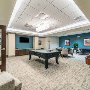Game room with pool table, poker table and shuffle board